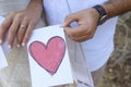 Guy and the girl hold the drawn heart on paper Royalty Free Stock Photo