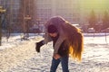 The guy and the girl indulge in the winter, he holds her on his shoulders and turns. A loving couple is playing outside Royalty Free Stock Photo