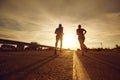 A guy and a girl jog along the road in nature. Royalty Free Stock Photo