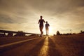 A guy and a girl jog along the road at sunset in nature. Royalty Free Stock Photo