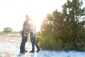 The guy with the girl kiss in the winter in the woods against the background of falling candy. Romantic winter atmosphere Royalty Free Stock Photo