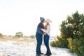 The guy with the girl kiss in the winter in the woods against the background of falling candy. Romantic winter atmosphere