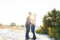 The guy with the girl kiss in the winter in the woods against the background of falling candy. Romantic winter atmosphere