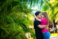 Guy and girl kissing near tropical plants Royalty Free Stock Photo
