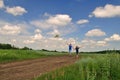 A guy with a girl launch a kite in the field Royalty Free Stock Photo