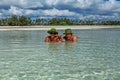 Guy and girl lie on the beach in the water Royalty Free Stock Photo