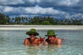 Guy and girl lie on the beach in the water Royalty Free Stock Photo