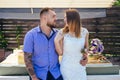 Guy and girl look at each other, portrait of a romantic couple,man and woman kissing in a dramatic light, girl holding flowers in