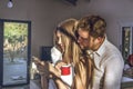 Guy and girl looking at their cell phones at home. Couple of guy and girl looking at their cell phone Royalty Free Stock Photo