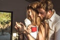 Guy and girl looking at their cell phones at home. Couple of guy and girl looking at their cell phone Royalty Free Stock Photo