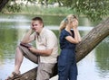 The guy and the girl in quarrel on the bank of the lake Royalty Free Stock Photo