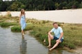 A guy and a girl are resting on the banks of a picturesque river Royalty Free Stock Photo