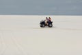 The guy and the girl ride a quad bike in the desert, having fun and enjoying, a couple of lovers Royalty Free Stock Photo