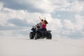 The guy and the girl ride a quad bike in the desert, having fun and enjoying, a couple of lovers Royalty Free Stock Photo