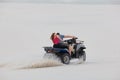 The guy and the girl ride a quad bike in the desert, having fun and enjoying, a couple of lovers Royalty Free Stock Photo