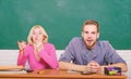 Guy and girl sit at desk in classroom. Wondering about result. Studying in college or university. Couple friends Royalty Free Stock Photo