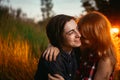 Guy and the girl sitting in the grass on a sunset background Royalty Free Stock Photo