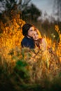 Guy and the girl sitting in the grass on a sunset background Royalty Free Stock Photo