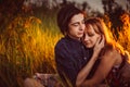 Guy and the girl sitting in the grass on a sunset background Royalty Free Stock Photo