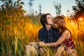 Guy and the girl sitting in the grass on a sunset background Royalty Free Stock Photo