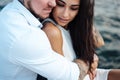 Young couple are sitting on the pier by the sea Royalty Free Stock Photo