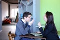 Guy and girl students relax in library after school and sit at t