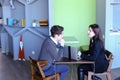 Guy and girl students relax in library after school and sit at t