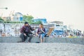 The guy and the girl are talking on the beach