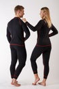 Guy and girl in thermal underwear on a white background Royalty Free Stock Photo