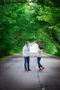 A guy and a girl in Ukrainian embroidered shirts are dancing on the road