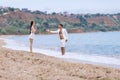 Guy and girl in white talking at waters edge Royalty Free Stock Photo