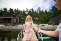 The guy gives his hand to the girl, helps to get into the boat on the pier Royalty Free Stock Photo