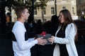 Guy gives the surprised girl gift. Happy birthday valentine day Royalty Free Stock Photo