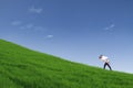 Guy giving piggyback ride on hill under blue sky