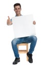 Guy giving a thumbs up and holding a billboard Royalty Free Stock Photo