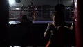 Guy in gloves beats a pear, in the ring there is a sparring of kickboxers. Slow motion