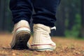 Guy goes in sneakers in the forest