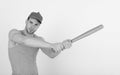 Guy in grey tank top holds bright green bat. Royalty Free Stock Photo