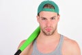 Guy in grey tank top holds bright green bat. Royalty Free Stock Photo