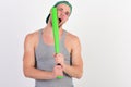 Guy in grey tank top holds bright green bat Royalty Free Stock Photo