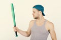 Guy in grey tank top holds bright green bat. Player with serious face plays baseball. Sports and baseball training Royalty Free Stock Photo