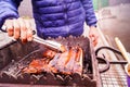 The guy grills ribs on the grill