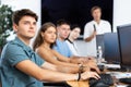 Guy with group of students listening to lecture in computer classroom Royalty Free Stock Photo