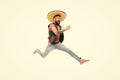 Guy happy cheerful face having fun dancing jumping. Life in motion. Man bearded cheerful guy wear sombrero mexican hat Royalty Free Stock Photo