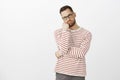 Guy hates how long boyfriend getting dressed. Portrait of tired and annoyed handsome european man in glasses, leaning Royalty Free Stock Photo