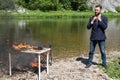 Guy hates this job. Crazy young man, hipster set fire to his desk, computer, laptop, phone. Infuriates office work Royalty Free Stock Photo