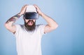 Guy in helmet works as engineer in virtual reality. 3D design concept. Man with beard in VR glasses shocked and