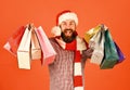 Guy or hipster shopper in red hat with shopping bags Royalty Free Stock Photo