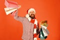 Guy or hipster shopper in red hat with shopping bags Royalty Free Stock Photo