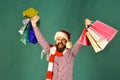 Guy or hipster shopper in red hat with shopping bags Royalty Free Stock Photo